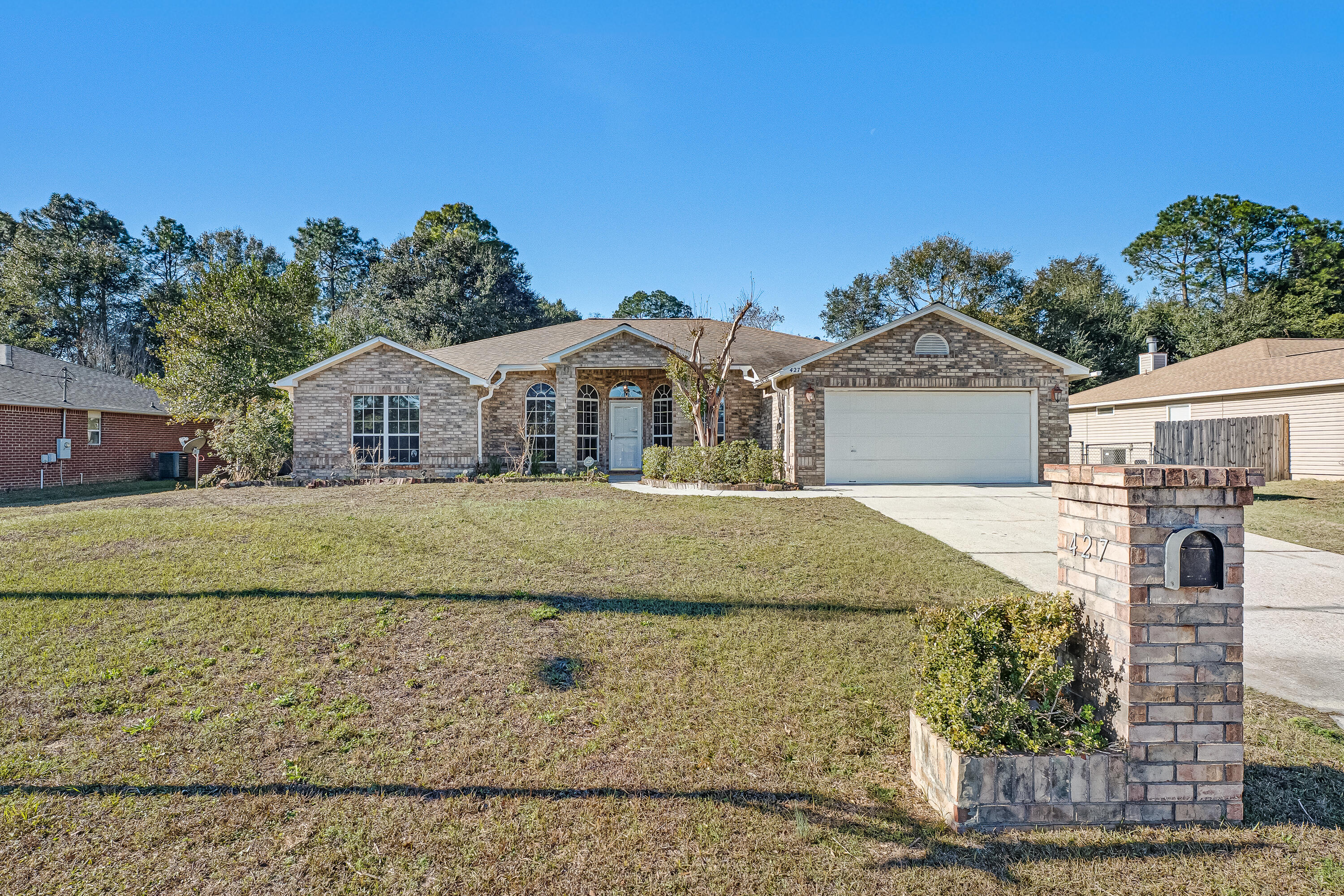 427 Hatchee Drive Crestview, FL 32536 - Photo 3 of 77 a front view of a house with a yard