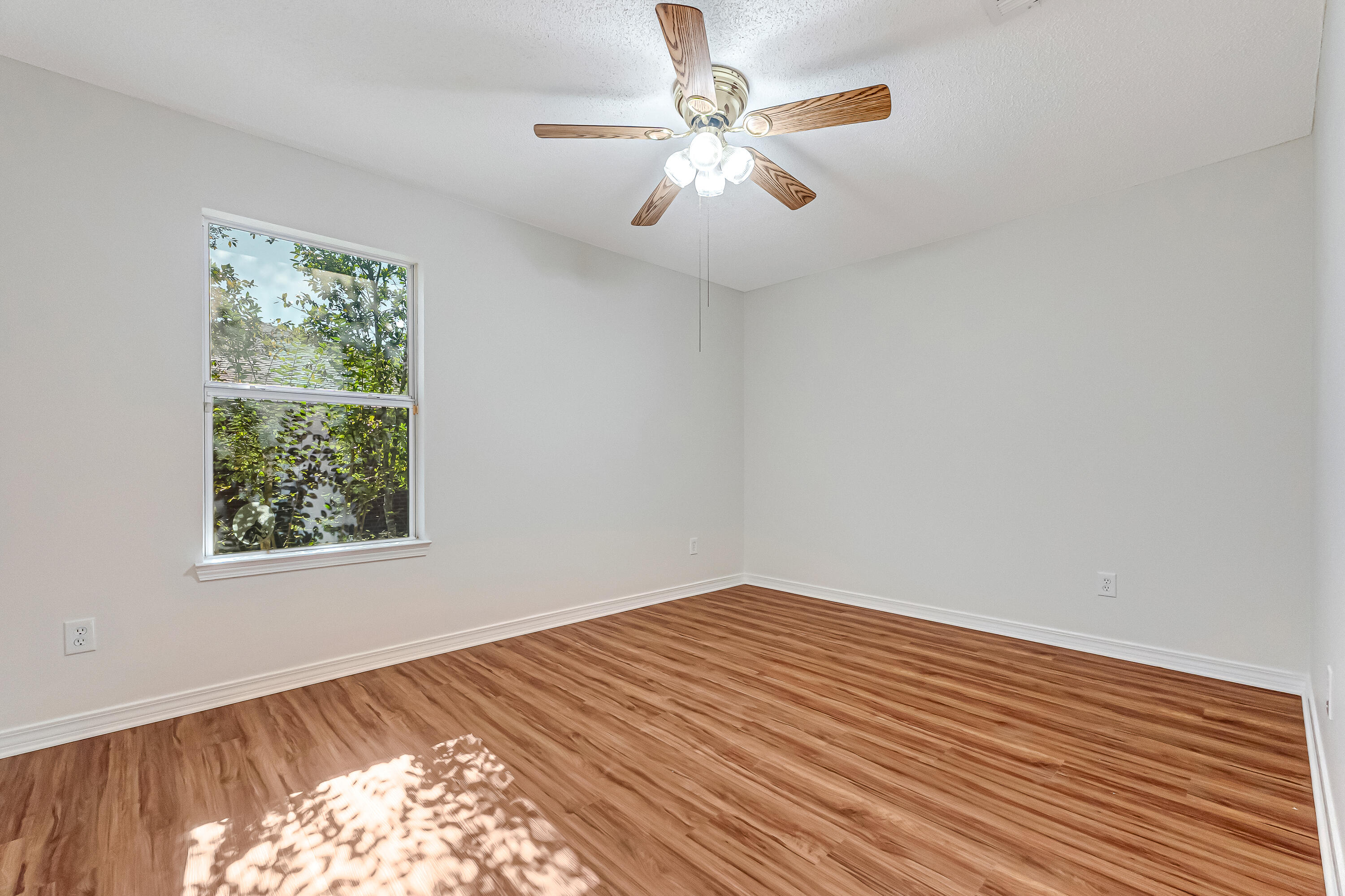 427 Hatchee Drive Crestview, FL 32536 - Photo 46 of 77 wooden floor in an empty room with a window