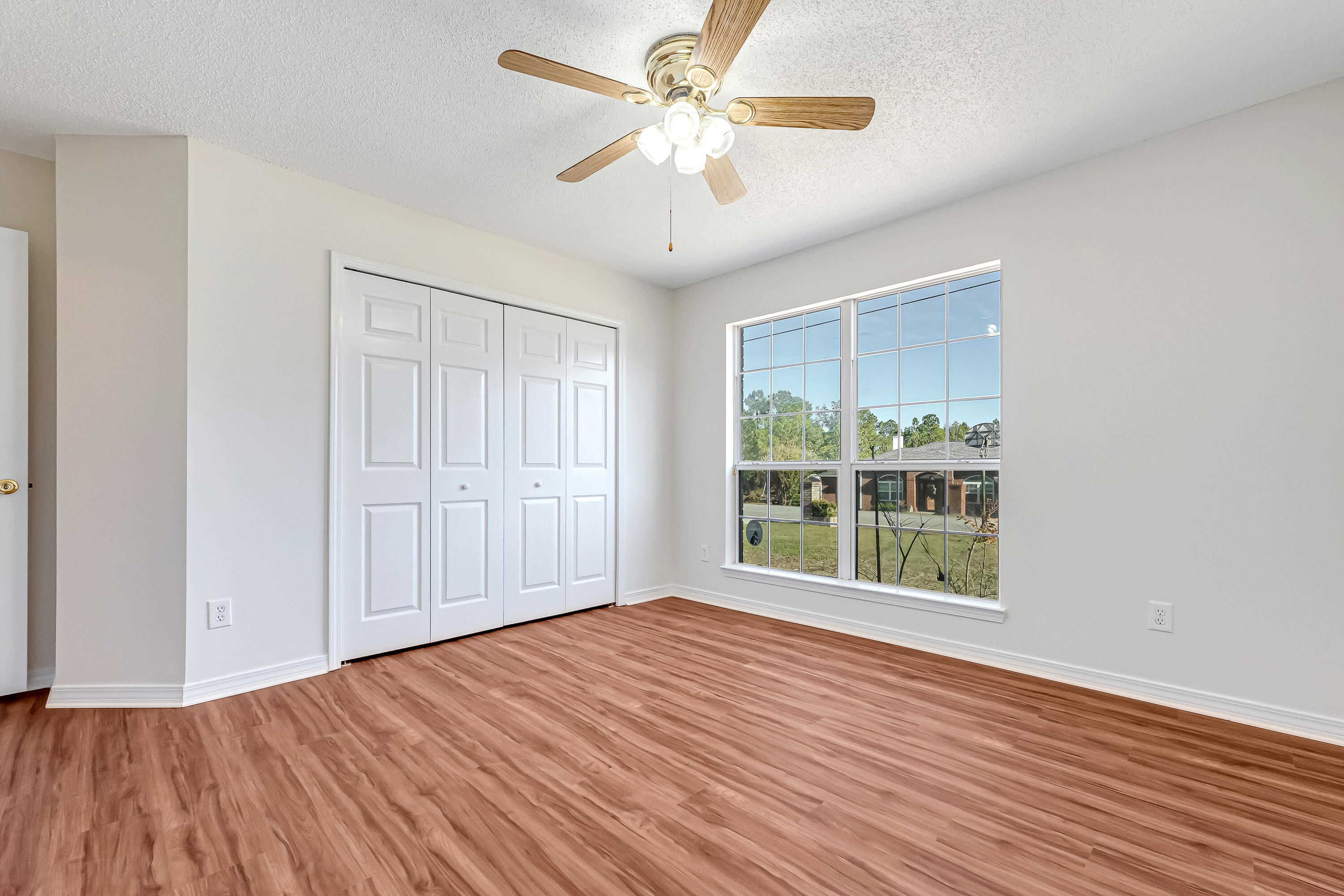 427 Hatchee Drive Crestview, FL 32536 - Photo 49 of 77 wooden floor in an empty room with a window