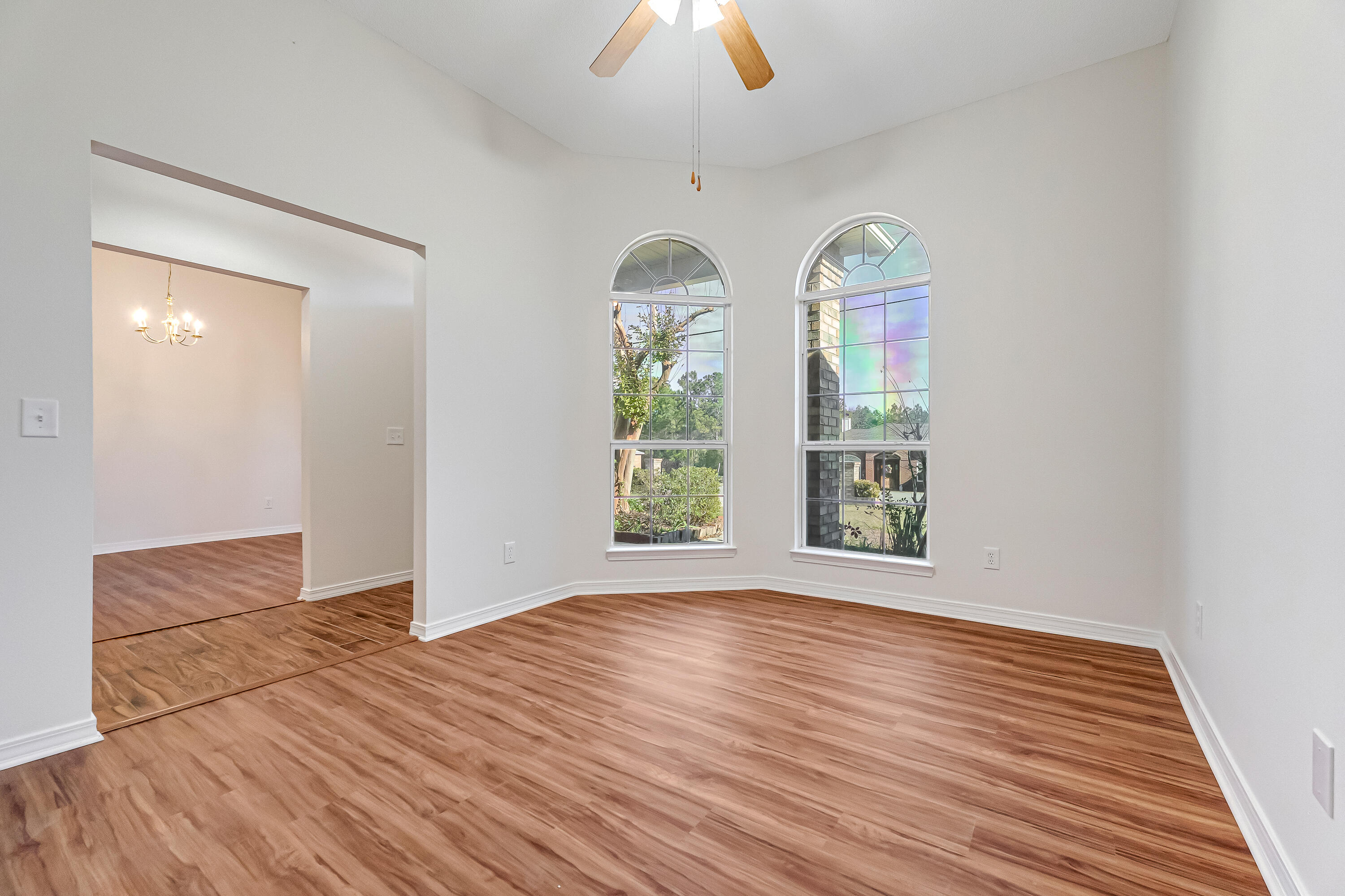 427 Hatchee Drive Crestview, FL 32536 - Photo 5 of 77 an empty room with wooden floor fan and windows