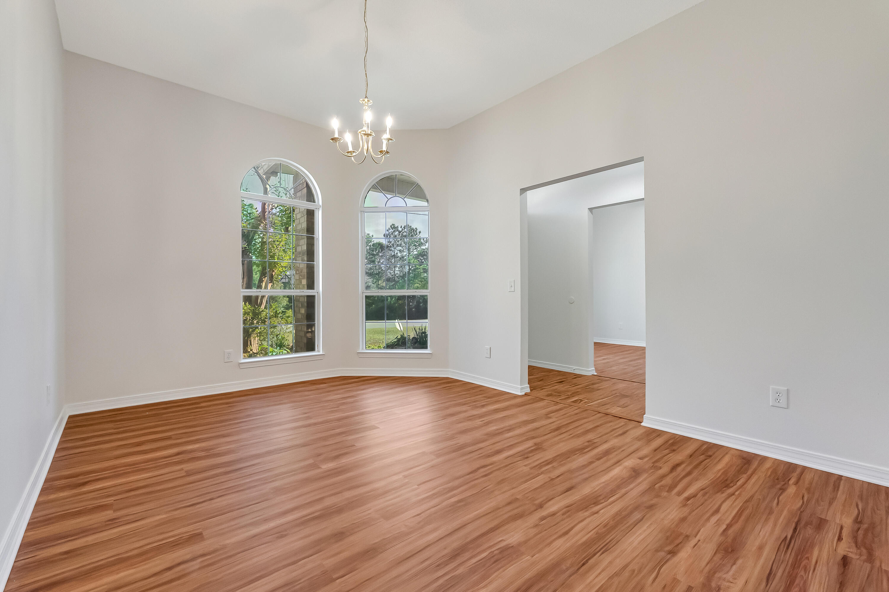 427 Hatchee Drive Crestview, FL 32536 - Photo 6 of 77 an empty room with wooden floor and windows