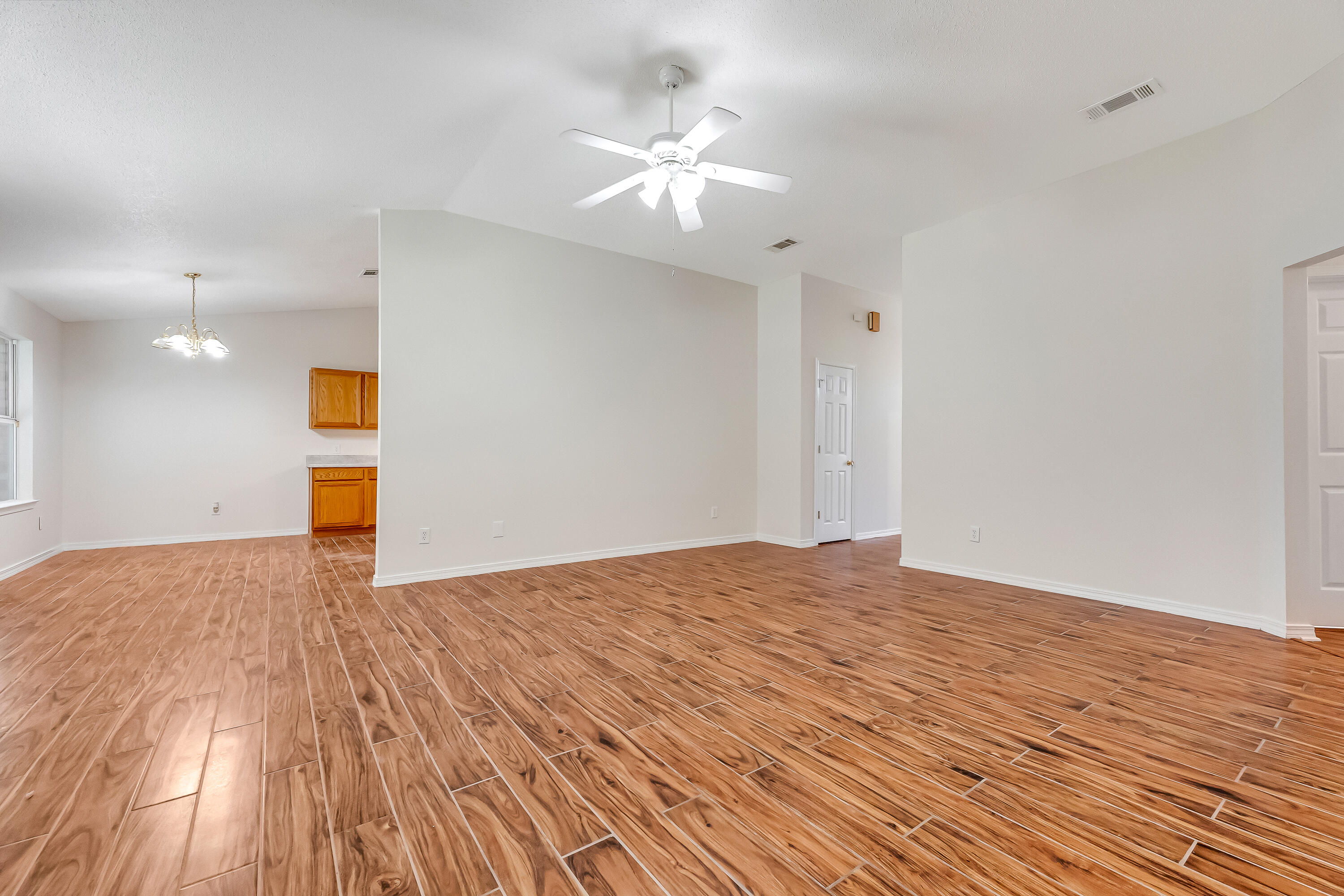 427 Hatchee Drive Crestview, FL 32536 - Photo 9 of 77 a view of an empty room and wooden floor