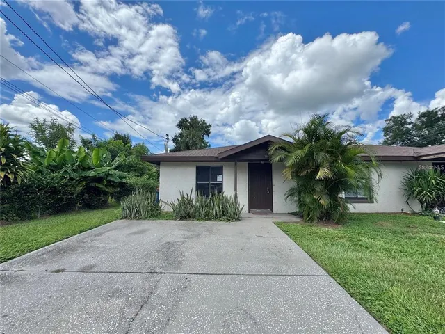 a front view of a house with a yard and a garage