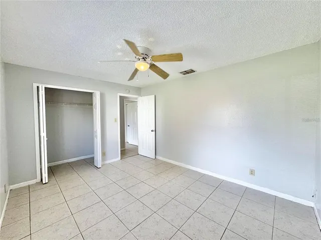 a kitchen with a refrigerator sink and cabinets
