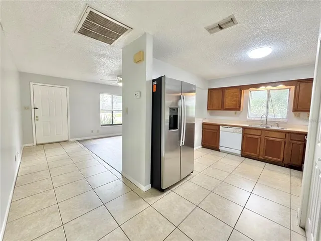 a large kitchen with cabinets and stainless steel appliances