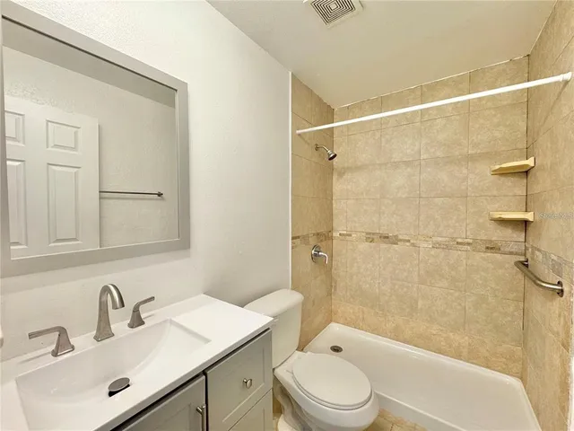 a bathroom with a toilet and shower