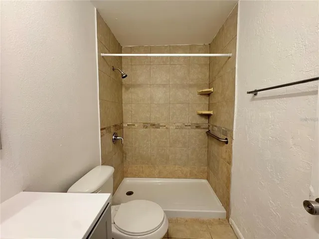 a view of room with a ceiling fan and carpet