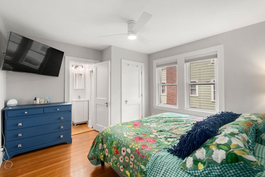 9 Dunton Road, Unit 9 Watertown, MA 02472 - Photo 17 of 39 a bedroom with a bed closet and flat tv screen