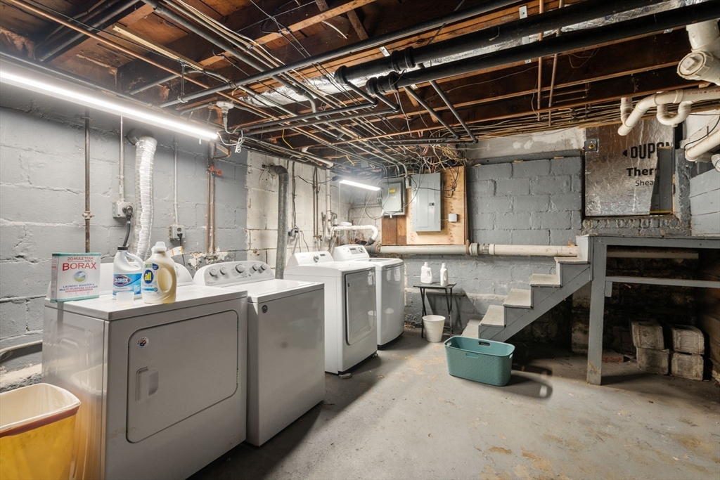 9 Dunton Road, Unit 9 Watertown, MA 02472 - Photo 25 of 39 a utility room with cabinets dryer and washer