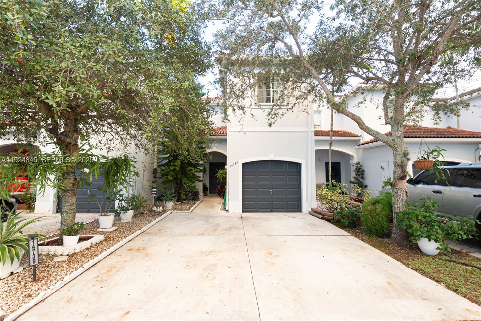 14738 Southwest 9th Lane Miami, FL 33194 - Photo 11 of 31 a front view of a house with yard and tree