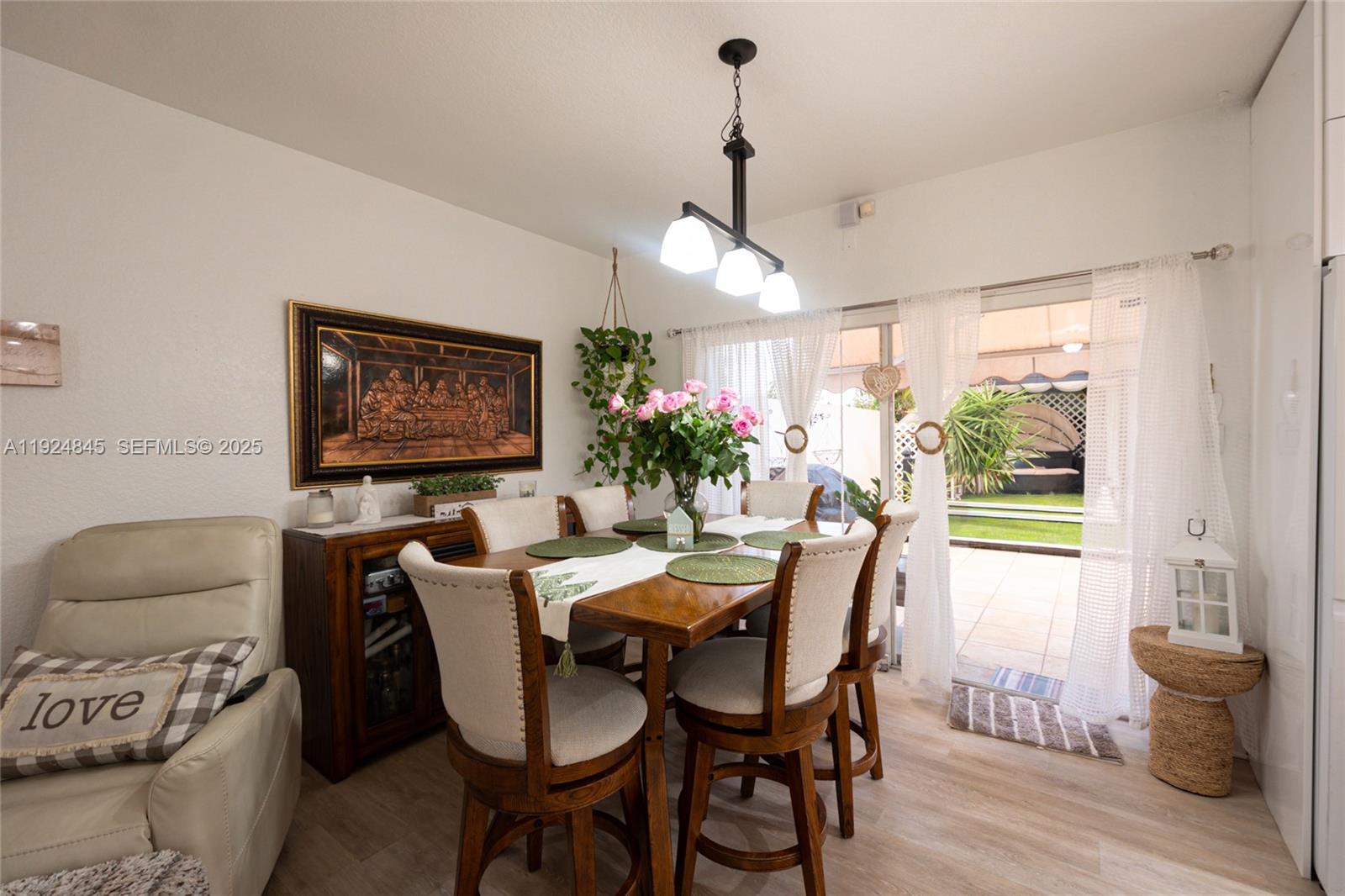 14738 Southwest 9th Lane Miami, FL 33194 - Photo 15 of 31 a view of a dining room with furniture window and wooden floor
