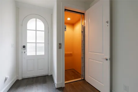 a kitchen with a refrigerator and white cabinets