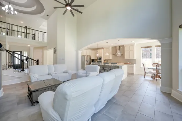 a living room with furniture and a chandelier