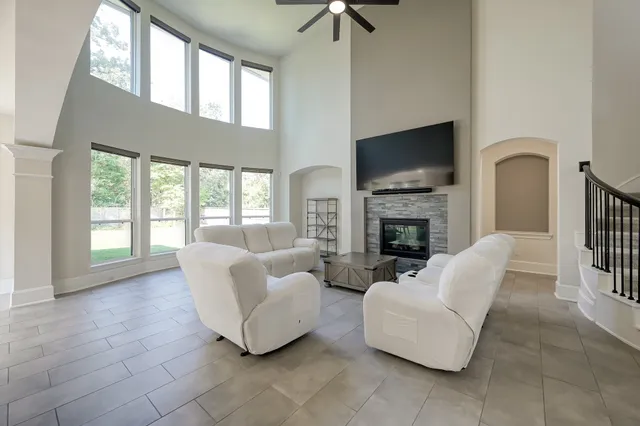 a living room with furniture a flat screen tv and a fireplace