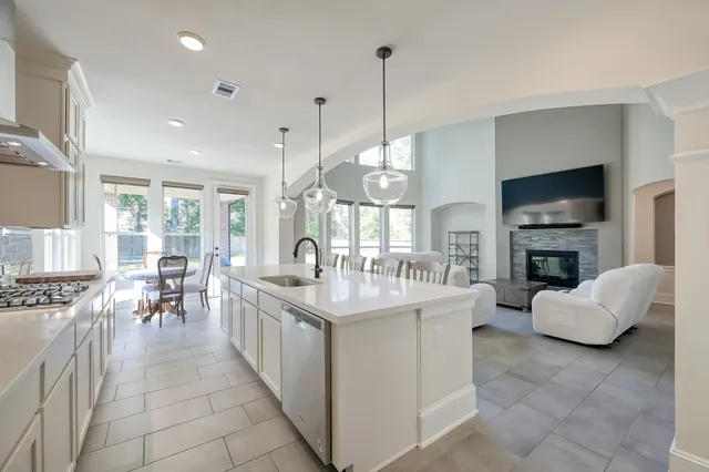 a view of a dining room with furniture large windows and wooden floor