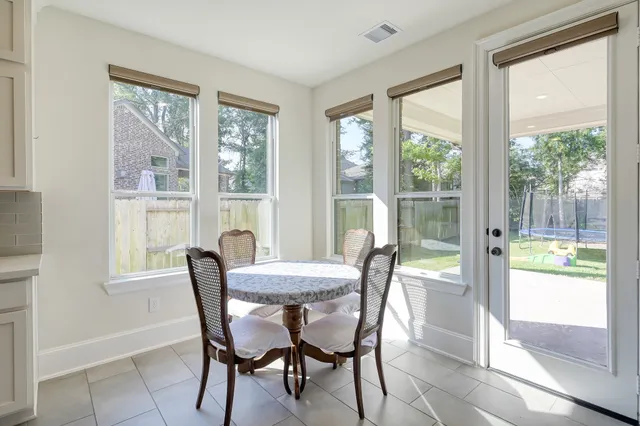 a spacious bedroom with a bed and a chandelier