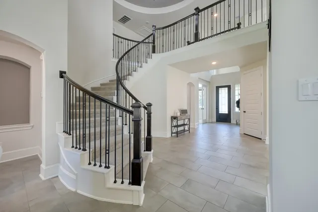 a view of staircase with white walls and a window