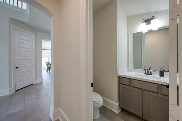 a bathroom with a toilet a sink and mirror