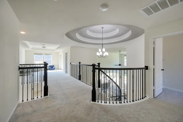 a view of a livingroom with furniture and a ceiling fan