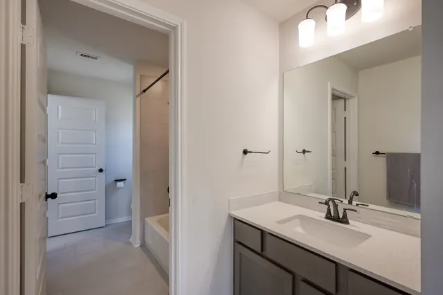 a backyard of a house with barbeque oven table and chairs