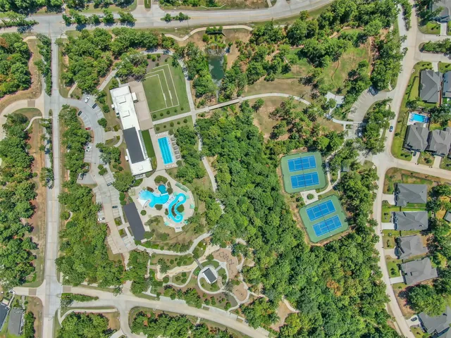 an aerial view of residential house with outdoor space and swimming pool