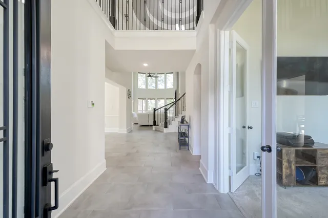 a view of a hallway with a livingroom and entryway