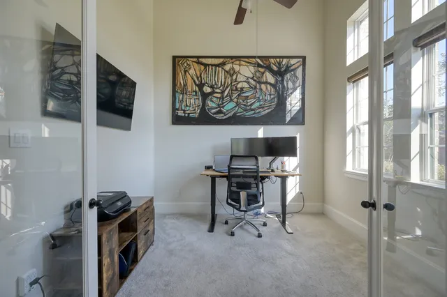a view of a workspace with furniture and a flat screen tv