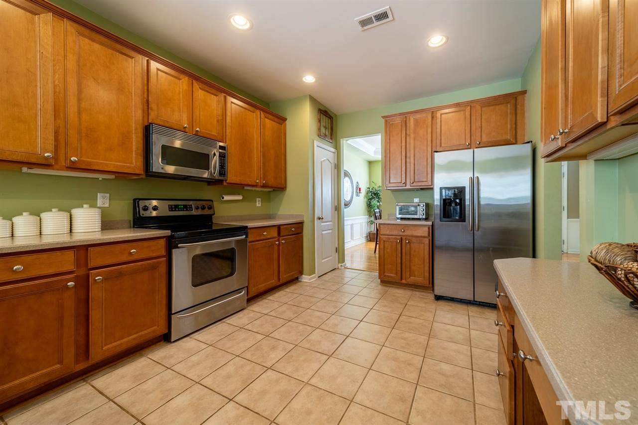 3314 Colorcott Street Raleigh, NC 27614 - Photo 2 of 12 a kitchen with stainless steel appliances granite countertop a refrigerator a stove top oven a sink and dishwasher