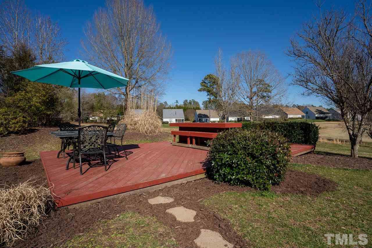 3314 Colorcott Street Raleigh, NC 27614 - Photo 12 of 12 a patio with a table and chairs under an umbrella