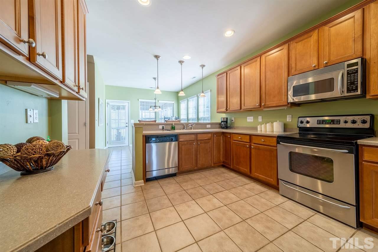3314 Colorcott Street Raleigh, NC 27614 - Photo 3 of 12 a kitchen with stainless steel appliances granite countertop a stove a sink dishwasher and a refrigerator