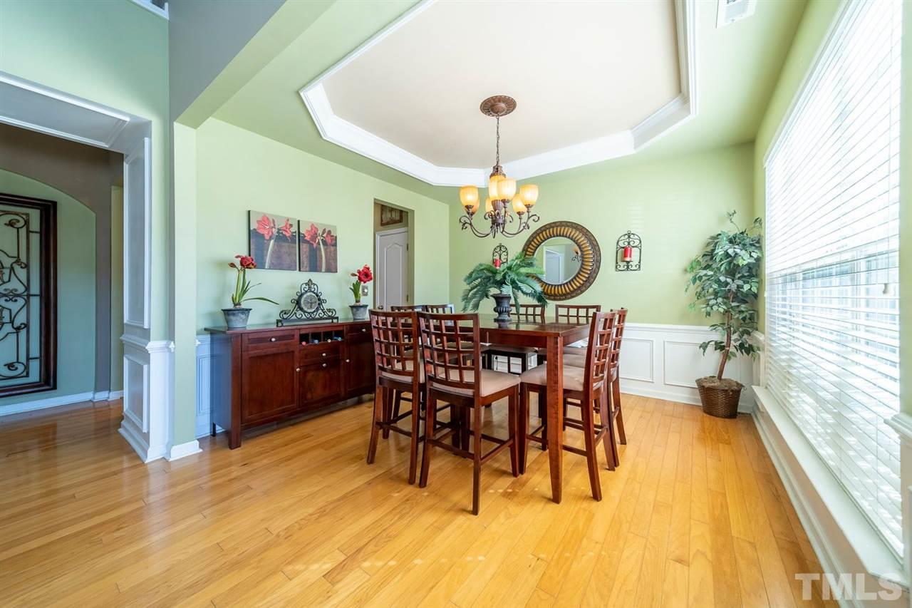 3314 Colorcott Street Raleigh, NC 27614 - Photo 4 of 12 a view of a dining room with furniture and wooden floor