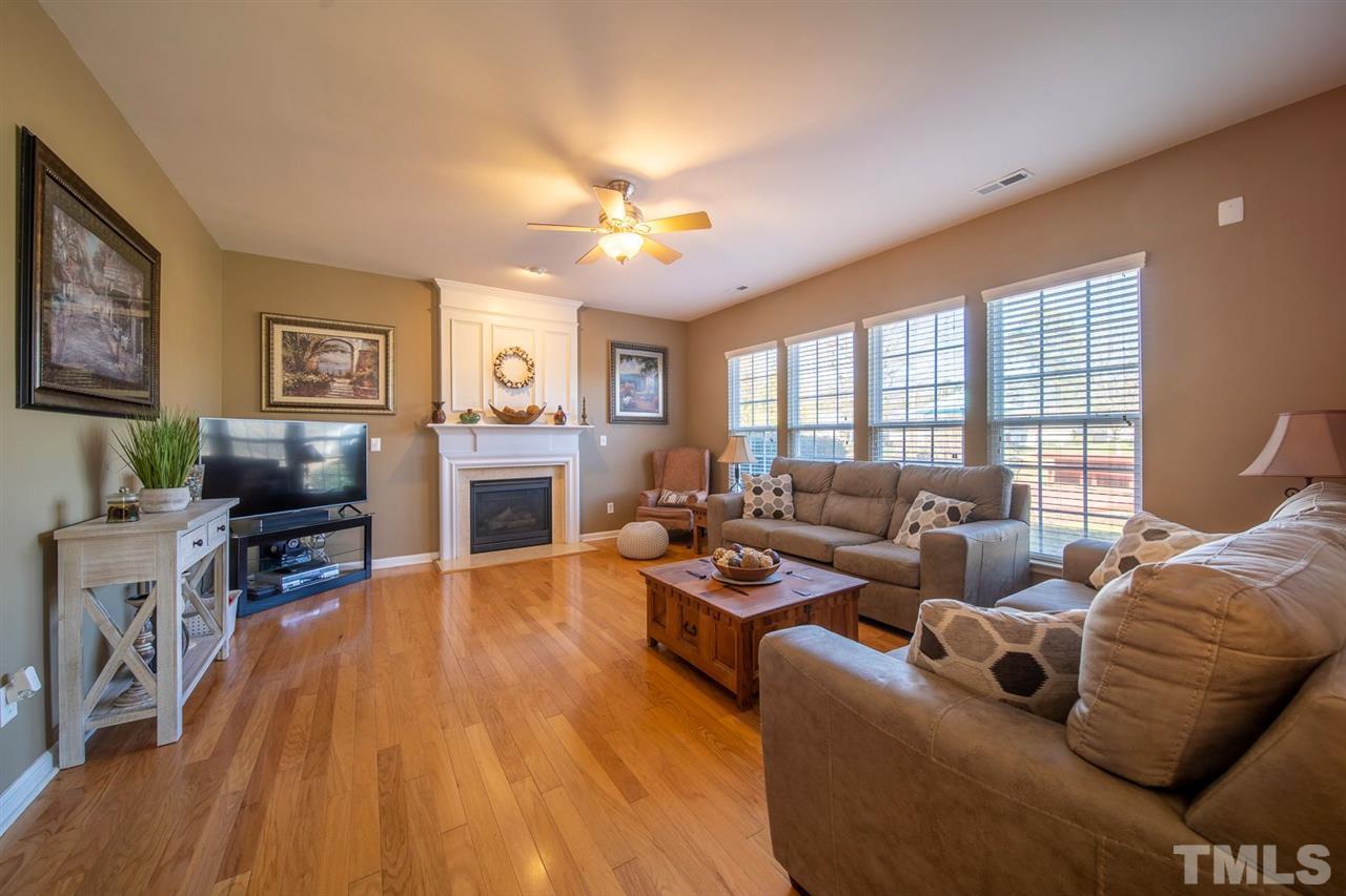 3314 Colorcott Street Raleigh, NC 27614 - Photo 5 of 12 a living room with fireplace furniture and a flat screen tv