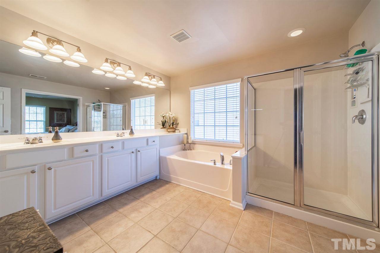 3314 Colorcott Street Raleigh, NC 27614 - Photo 8 of 12 a spacious bathroom with a tub sink and mirror