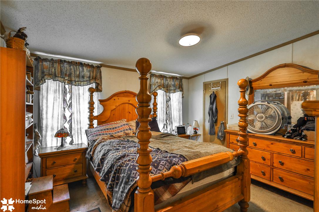 3795 Rhoades Road Kempton, PA 19529 - Photo 15 of 42 A comforting bedroom showcasing classic wooden furnishings and soft, diffused light from window treatments.