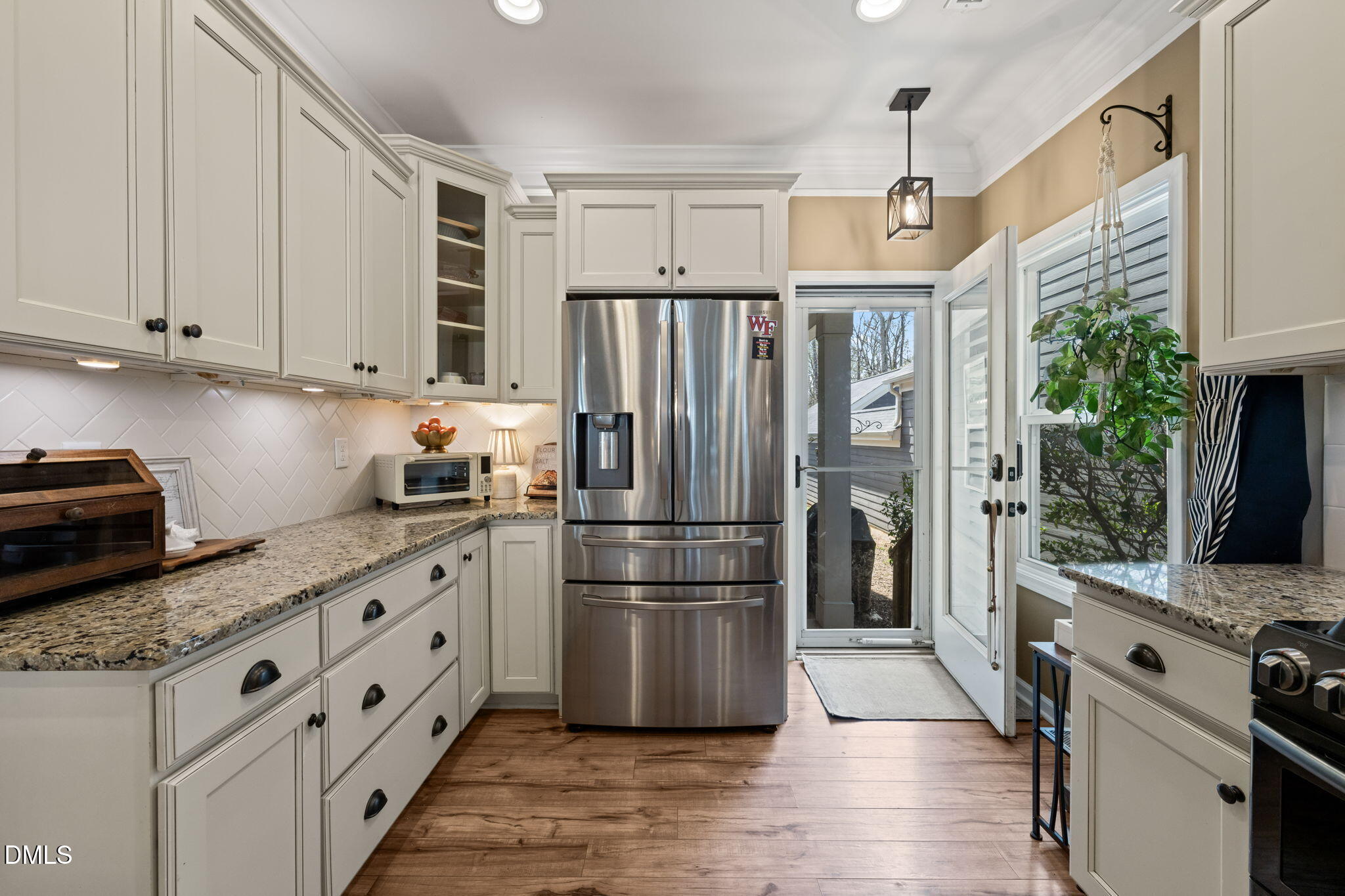 1716 Main Divide Drive Wake Forest, NC 27587 - Photo 14 of 45 a kitchen with granite countertop a refrigerator and a stove top oven
