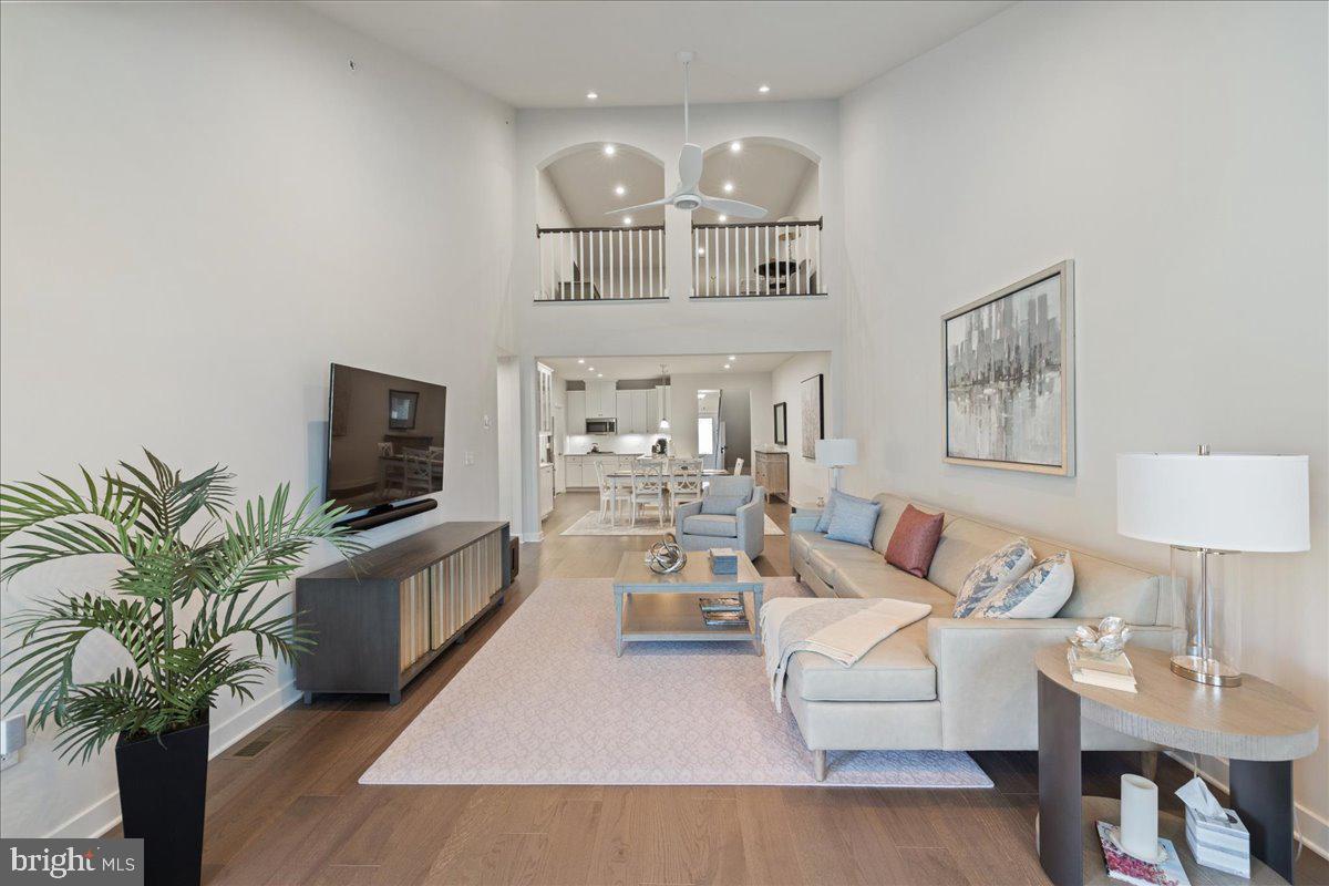 34 Griffin Way Yardley, PA 19067 - Photo 16 of 50 a living room with furniture a chandelier and a flat screen tv