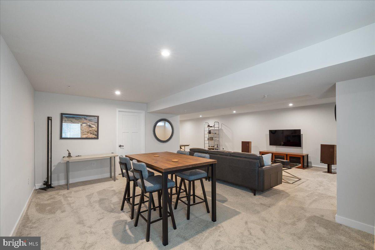 34 Griffin Way Yardley, PA 19067 - Photo 36 of 50 a living room with a table chairs and a flat screen tv