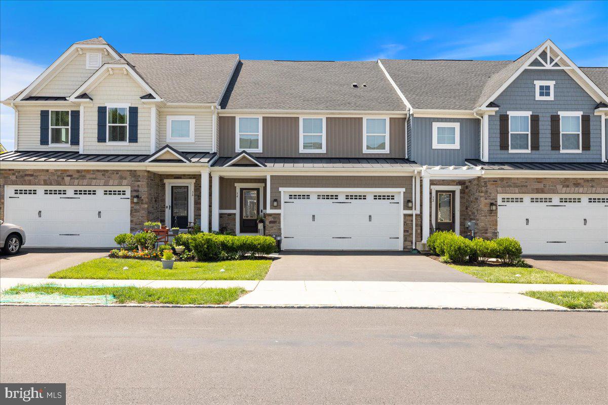 34 Griffin Way Yardley, PA 19067 - Photo 4 of 50 a front view of a house with a yard and garage