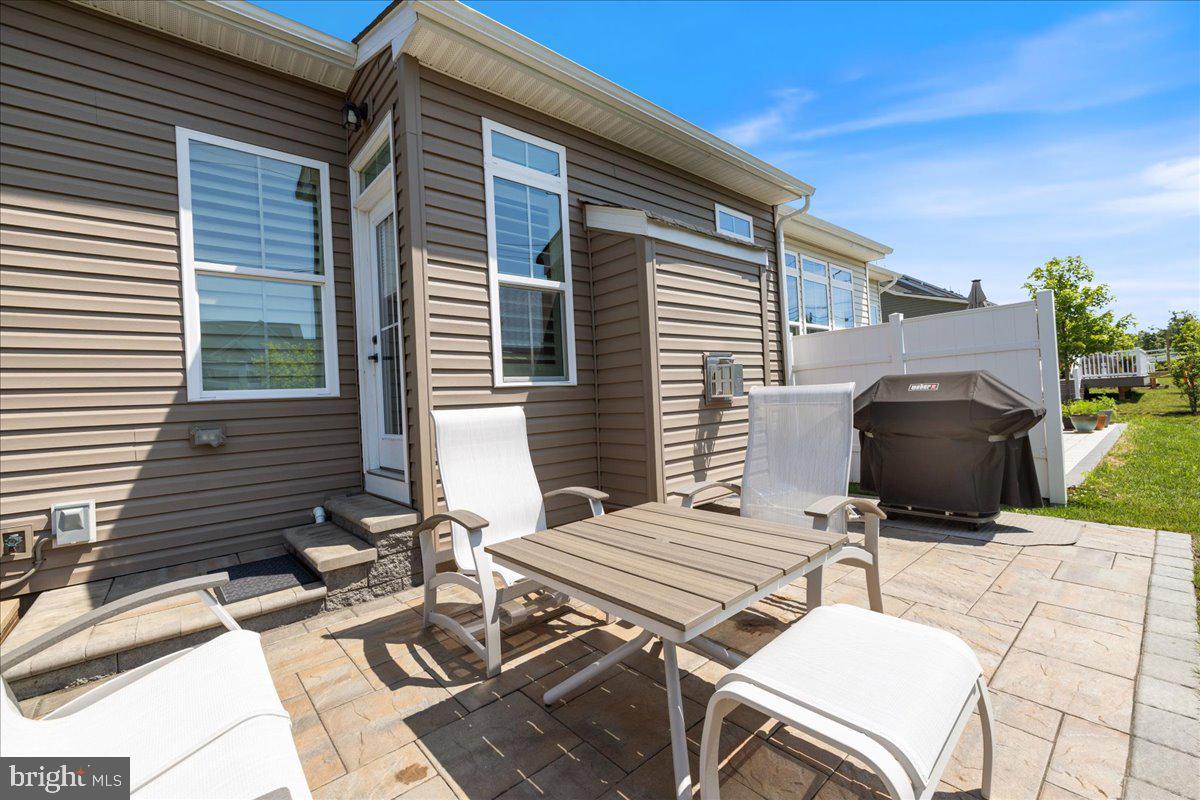 34 Griffin Way Yardley, PA 19067 - Photo 46 of 50 a patio with table and chairs and potted plants