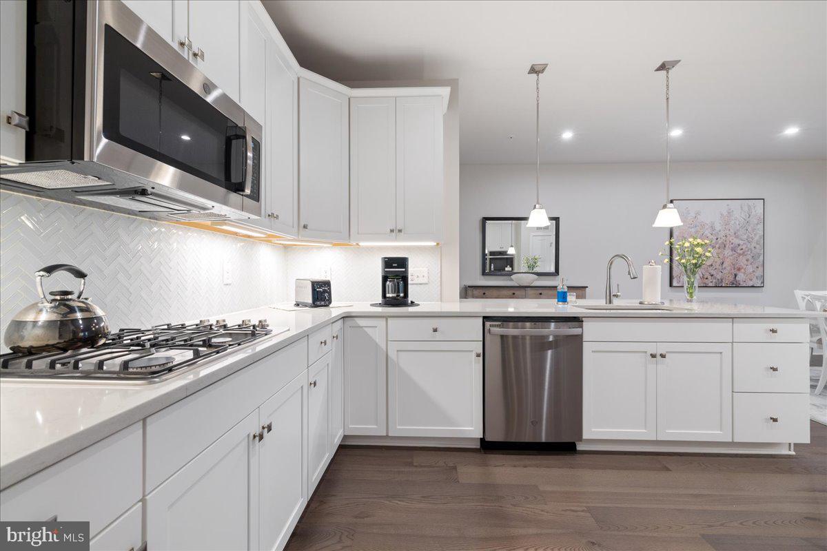 34 Griffin Way Yardley, PA 19067 - Photo 9 of 50 a kitchen with white cabinets stainless steel appliances and sink