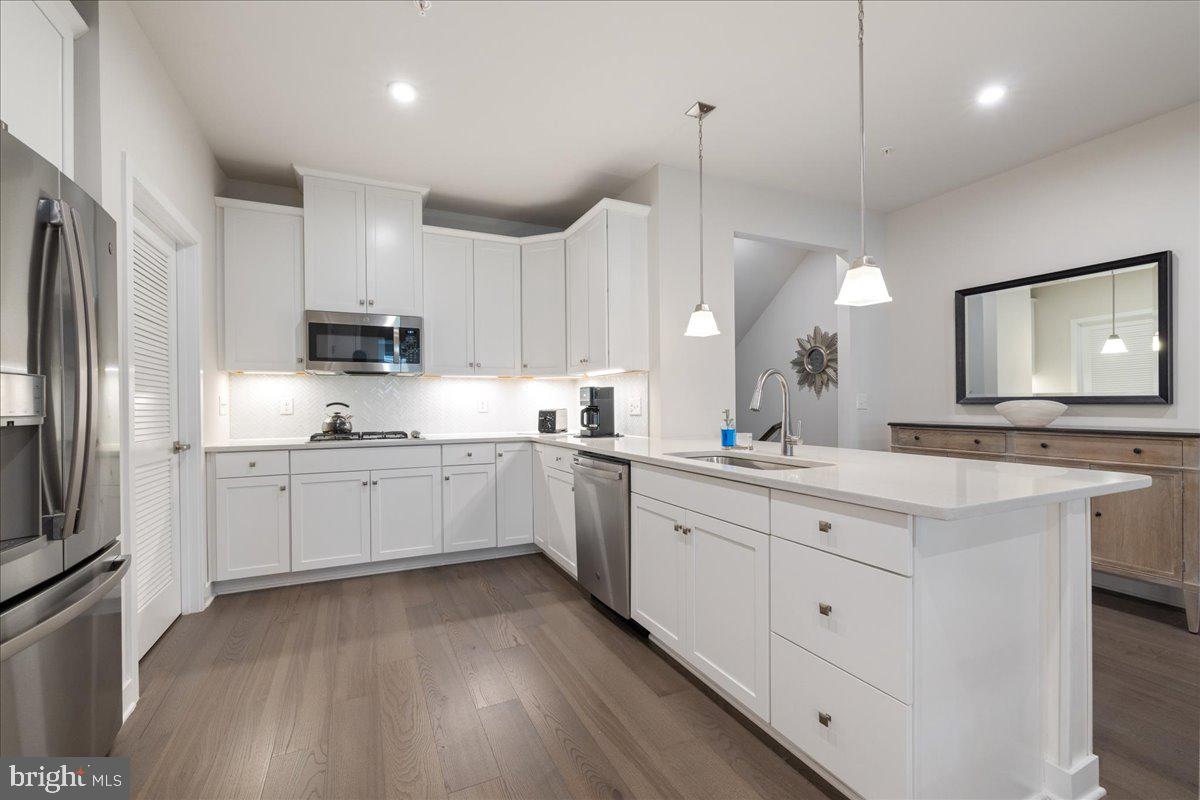 34 Griffin Way Yardley, PA 19067 - Photo 10 of 50 a kitchen with kitchen island granite countertop a sink a counter space appliances and cabinets