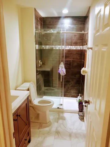 a bathroom with a shower and a sink