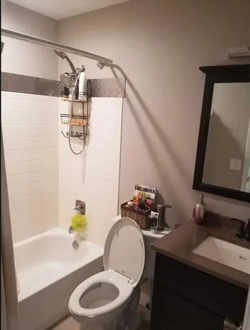 a bathroom with a sink mirror vanity and toilet