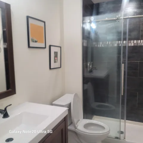 a bathroom with a sink toilet and shower
