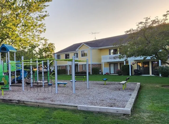 a view of a house with a yard and sitting area