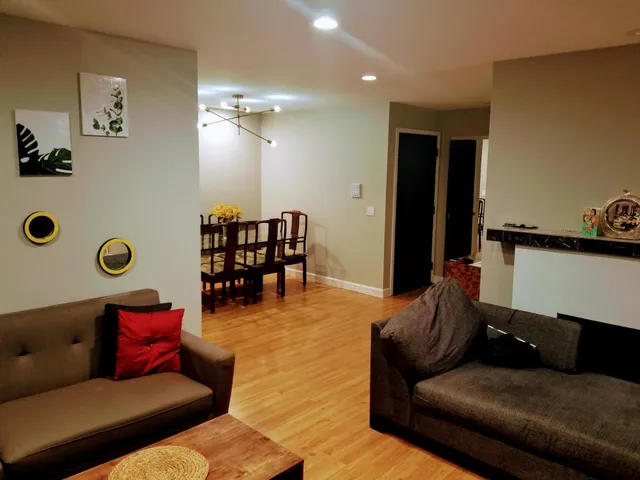 a living room with furniture and wooden floor