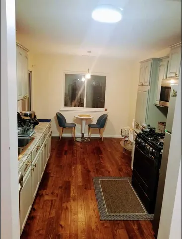 a living room with wooden floor and furniture
