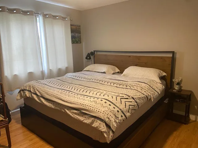 a bedroom with a bed and a mirror