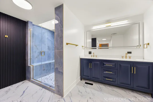 a bathroom with a granite countertop sink mirror and shower