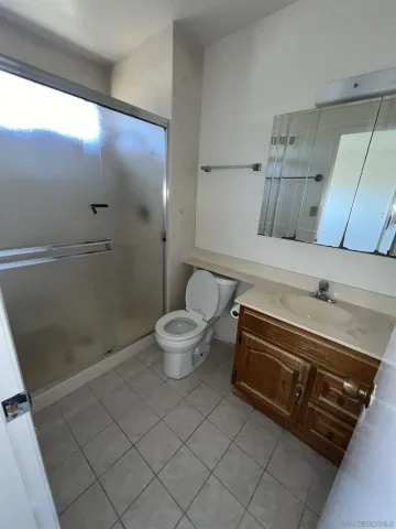 a spacious bathroom with a toilet and a shower